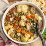 This is a square picture of a bowl or cauliflower lentil soup.