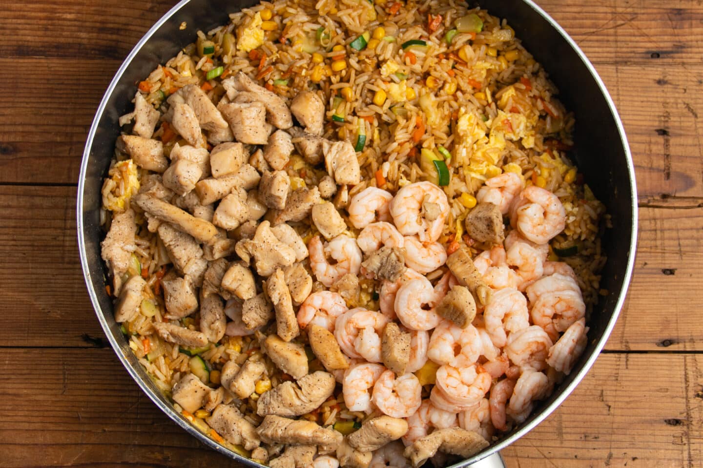 This is a picture of the fried rice in the skillet with shrimp and chicken added back in.