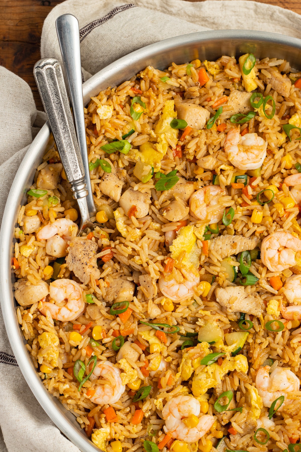 This is a picture of chicken and shrimp fried rice in a skillet.