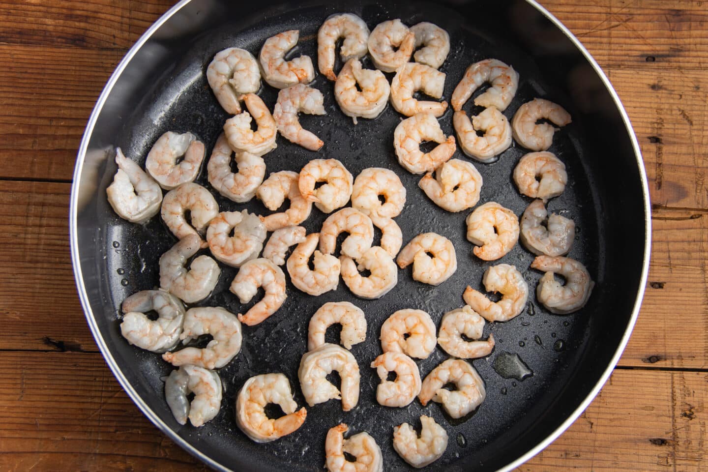 This is a picture of the shrimp cooking in a skillet.