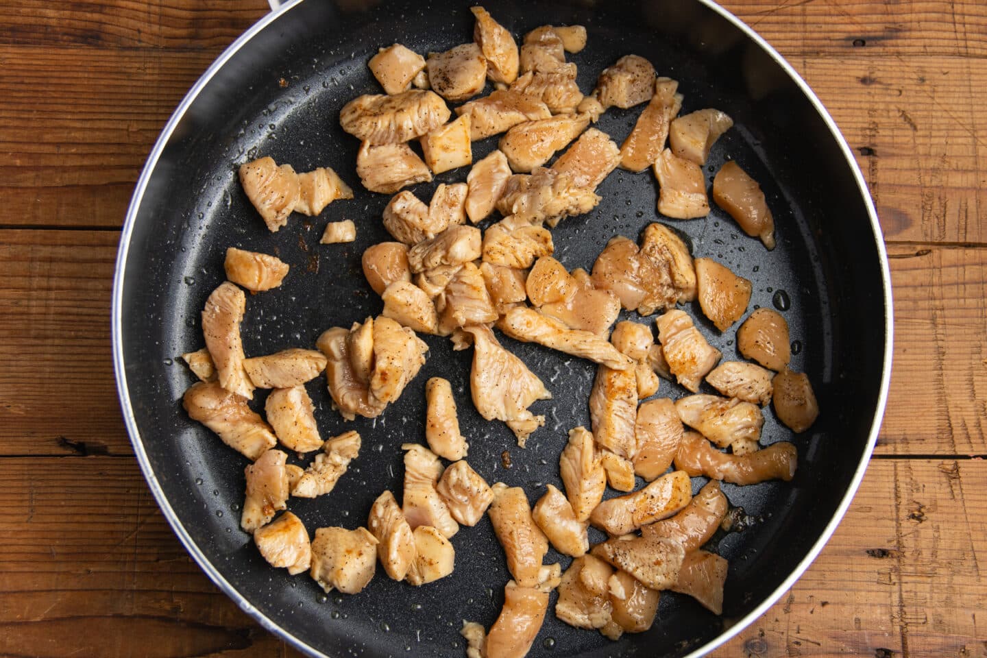 This is a picture of the chicken cooking in a skillet.