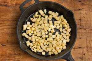 This is a picture of a skillet with cubed potatoes.