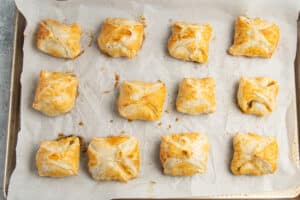 This is a picture of the puff pastry out of the oven on a baking sheet.