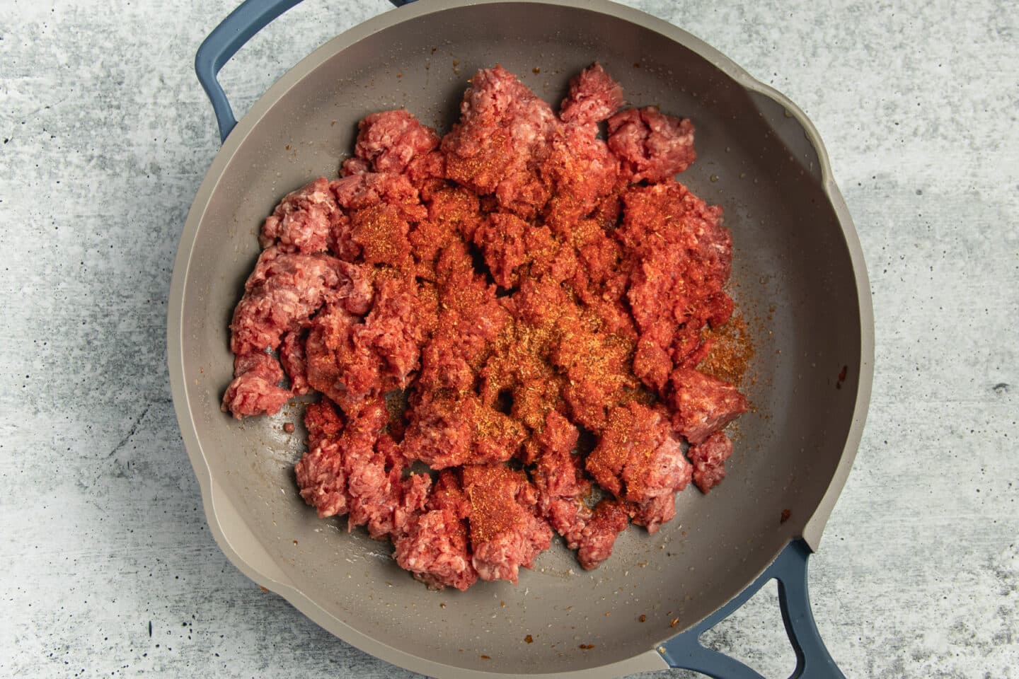 This is a picture of ground beef and seasoning in a skillet.