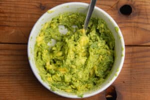 This is a picture of a bowl with smashed avocado.