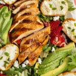This is a picture of the grilled chicken salad with goat cheese, avocado and strawberries.