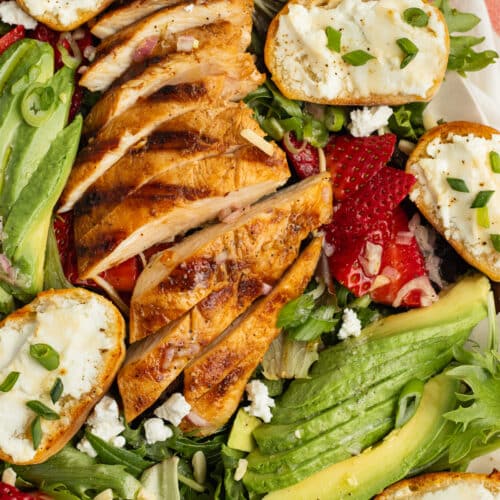 This is a picture of the grilled chicken salad with goat cheese, avocado and strawberries.