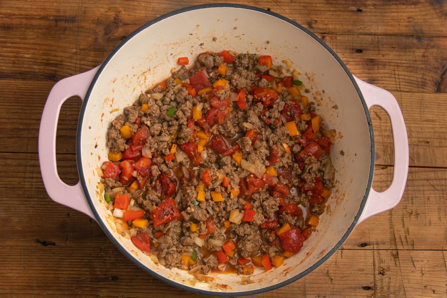 This is a picture of the pot with tomatoes added to the veggies and the beef.