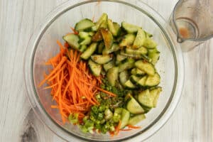 This is a picture of all the veggies and dressing together in a bowl.