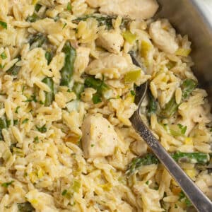 This is a square picture of the chicken boursin orzo in a skillet.
