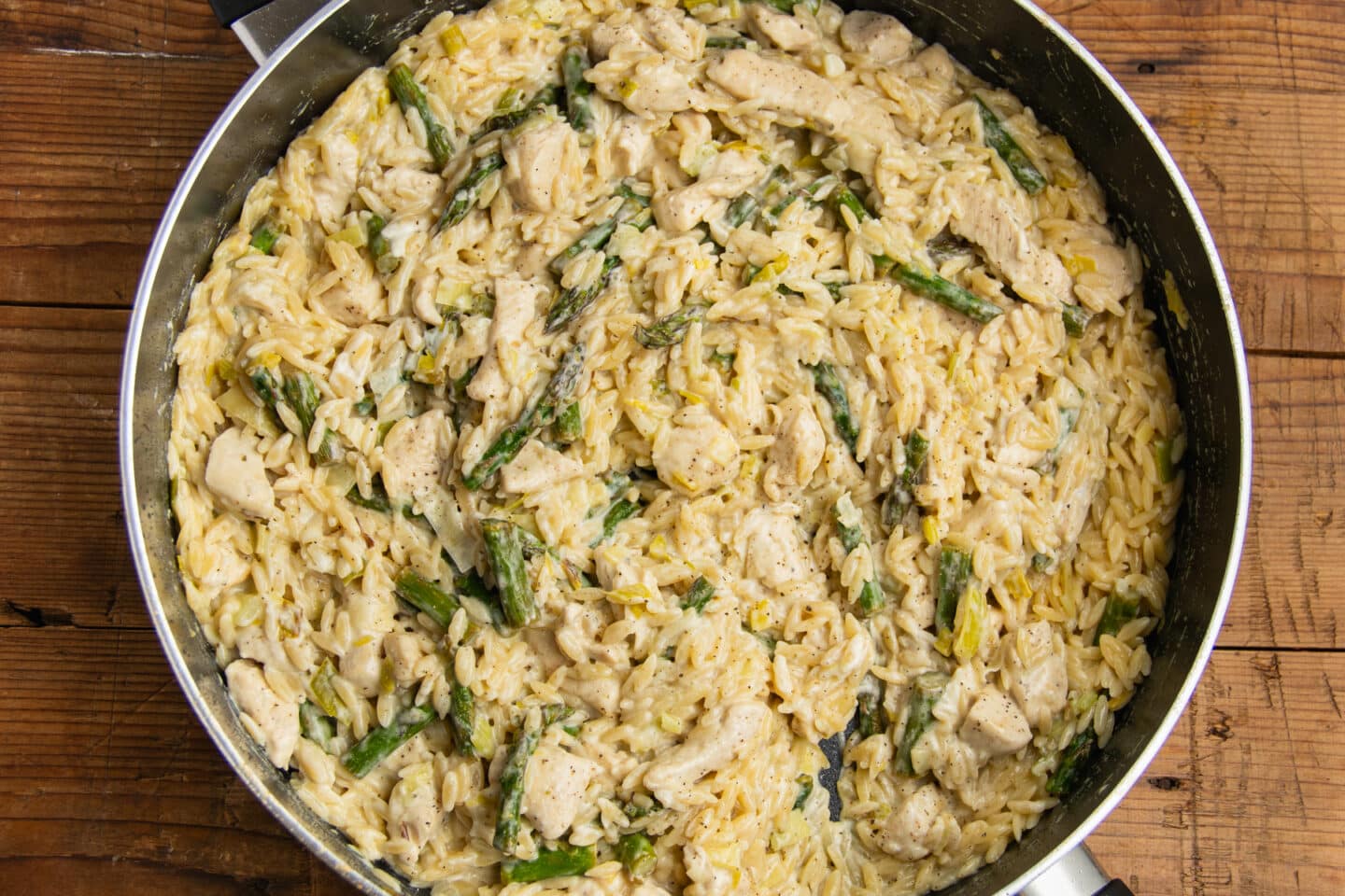 This is a picture of the skillet with the cheese, chicken and asparagus added.