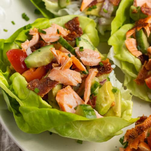 This is a square picture of a salmon lettuce wrap ready to eat.