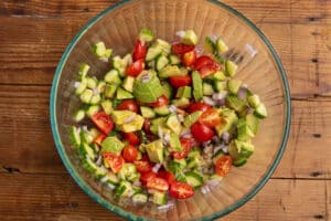 This is a picture of the cucumber, tomatoes, avocado tossed with dressing.