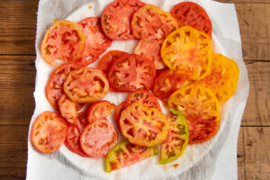 This is a picture of tomatoes salted and set on paper towels.
