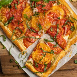 This is a square picture of the goat cheese tomato puff pastry tart.