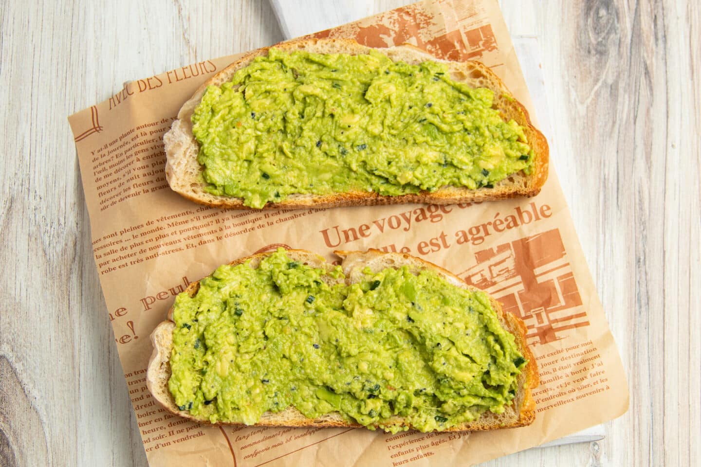 This is a picture of 2 toasts with smashed avocado.