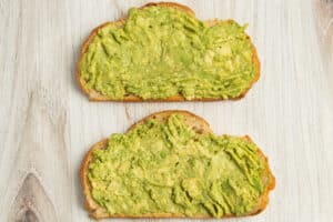 This is a picture of 2 toasts with smashed avocado.