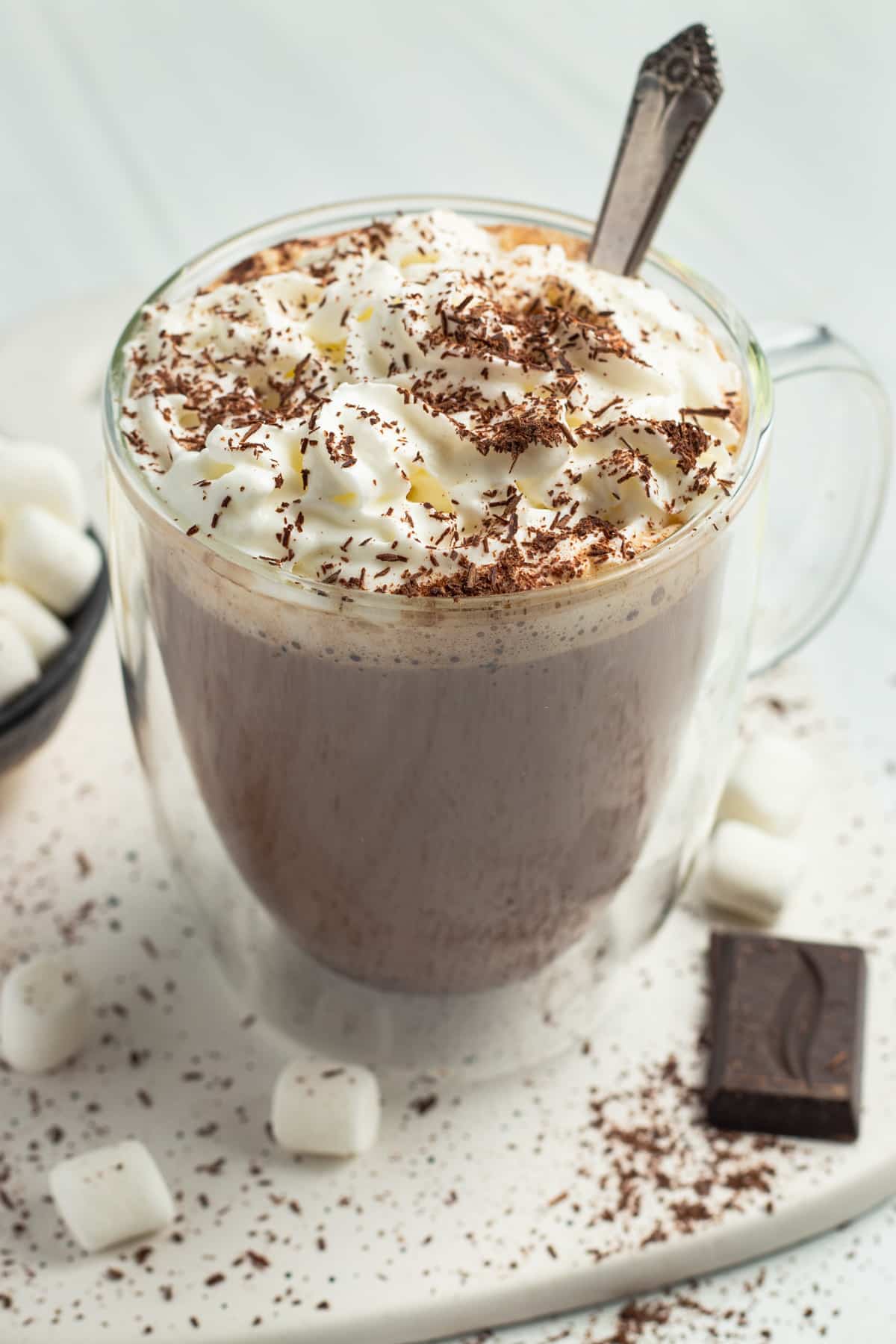 This is a picture of bone broth hot chocolate with whipped cream and shaved chocolate.