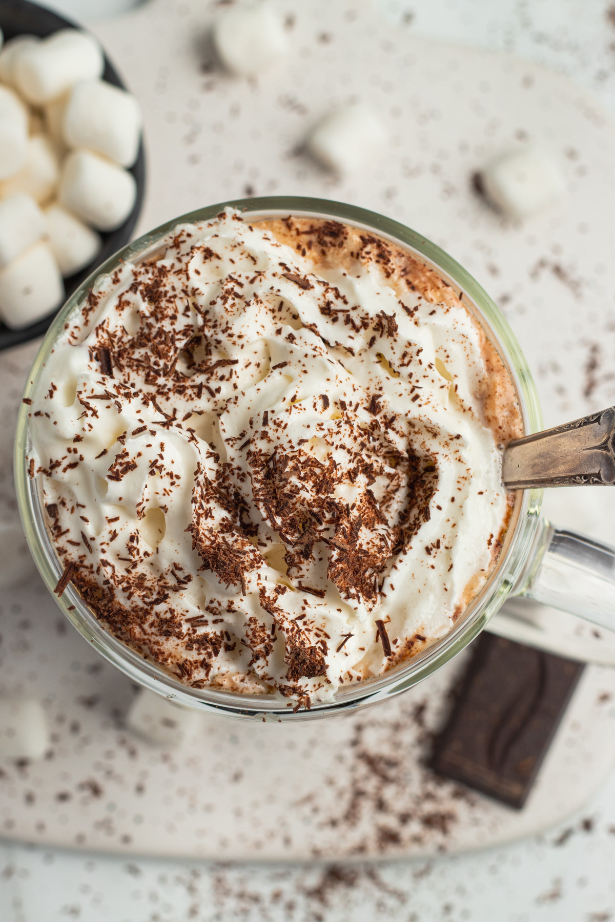 This is a picture of hot chocolate with whipped cream and shaved chocolate.