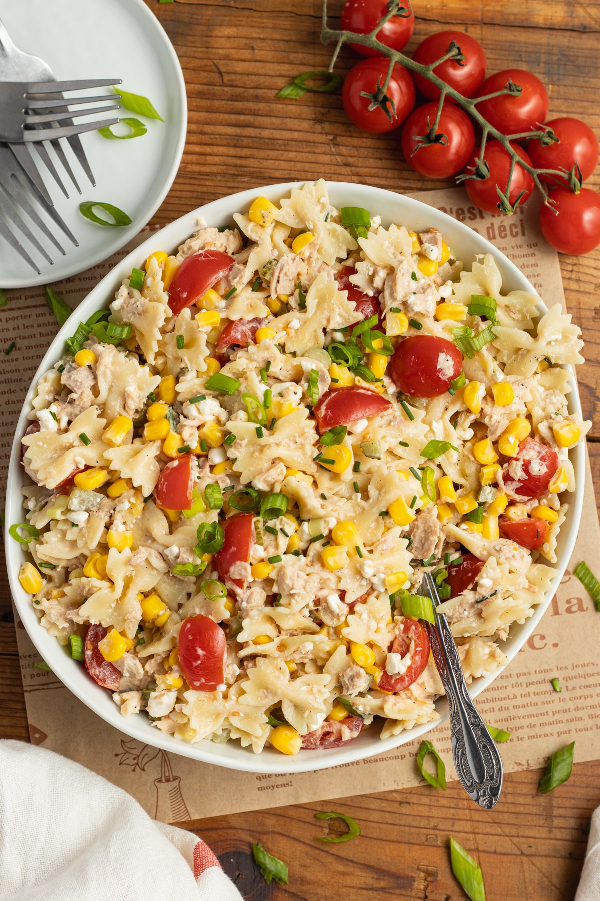 This is a picture of a large bowl filled with tuna and corn pasta salad.