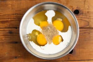 This is a picture of a large bowl with the eggs, seasoning and half and half.