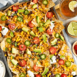 This is square picture of a platter of healthy nachos with chicken.