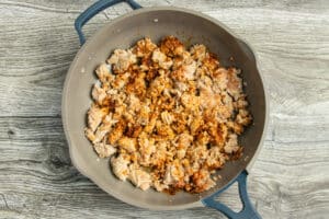This is a picture of a skillet with the ground chicken cooking.
