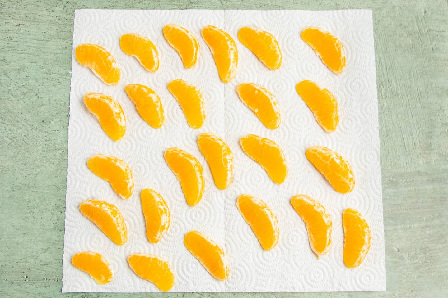 This is a picture of orange pieces on a paper towel.