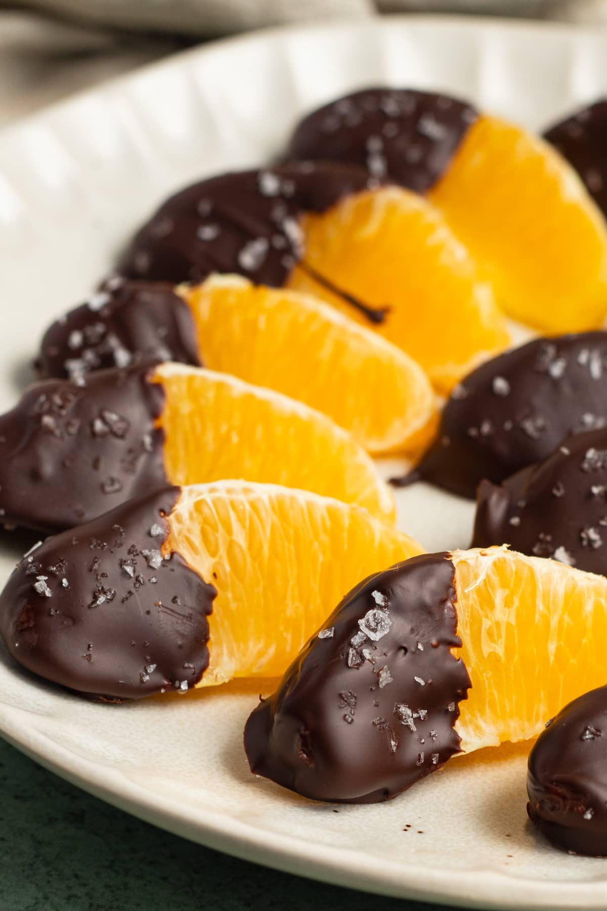 This is a picture of a plate of chocolate dipped oranges.