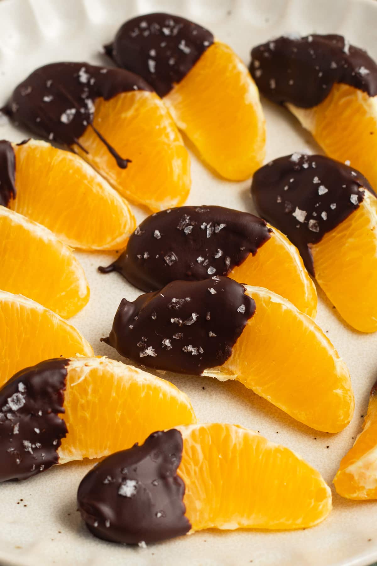 This is a picture of a plate of chocolate dipped oranges.