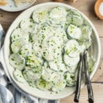 This is a square picture of a bowl of creamy French cucumber salad.