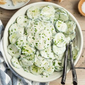 This is a square picture of a bowl of creamy French cucumber salad.