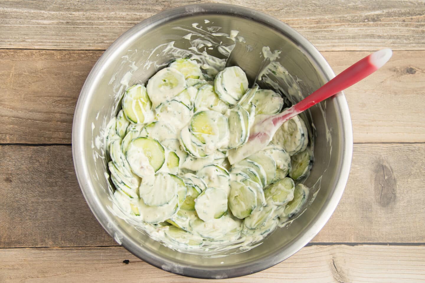 This is a picture of a bowl with the cucumber tossed in the creamy dressing.
