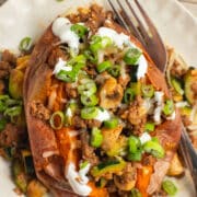 This is a square picture of a ground beef stuffed sweet potato.