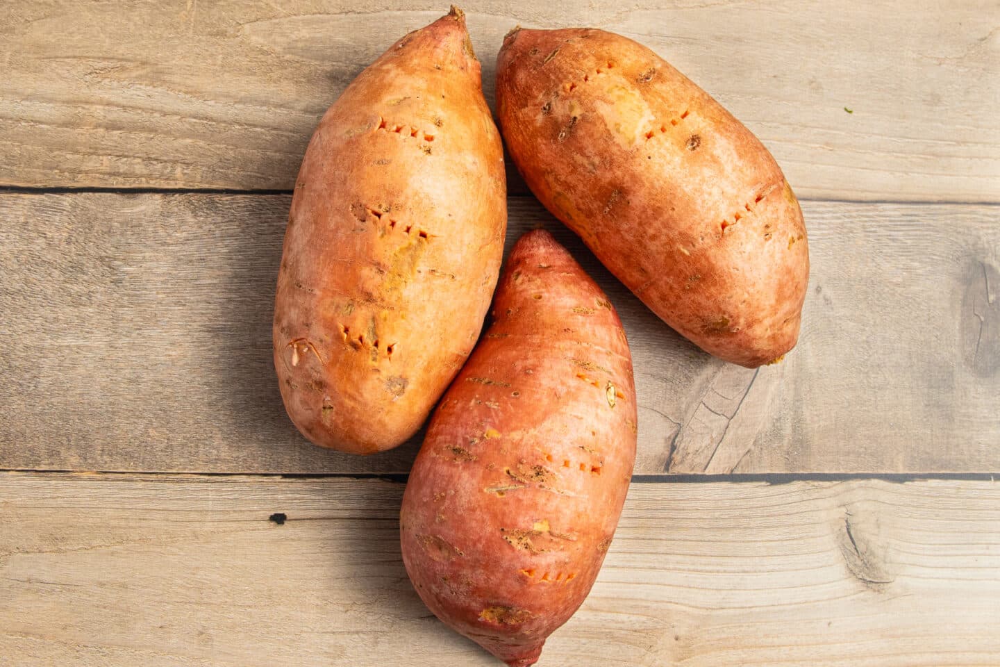 This is a picture of sweet potatoes poked with a fork.