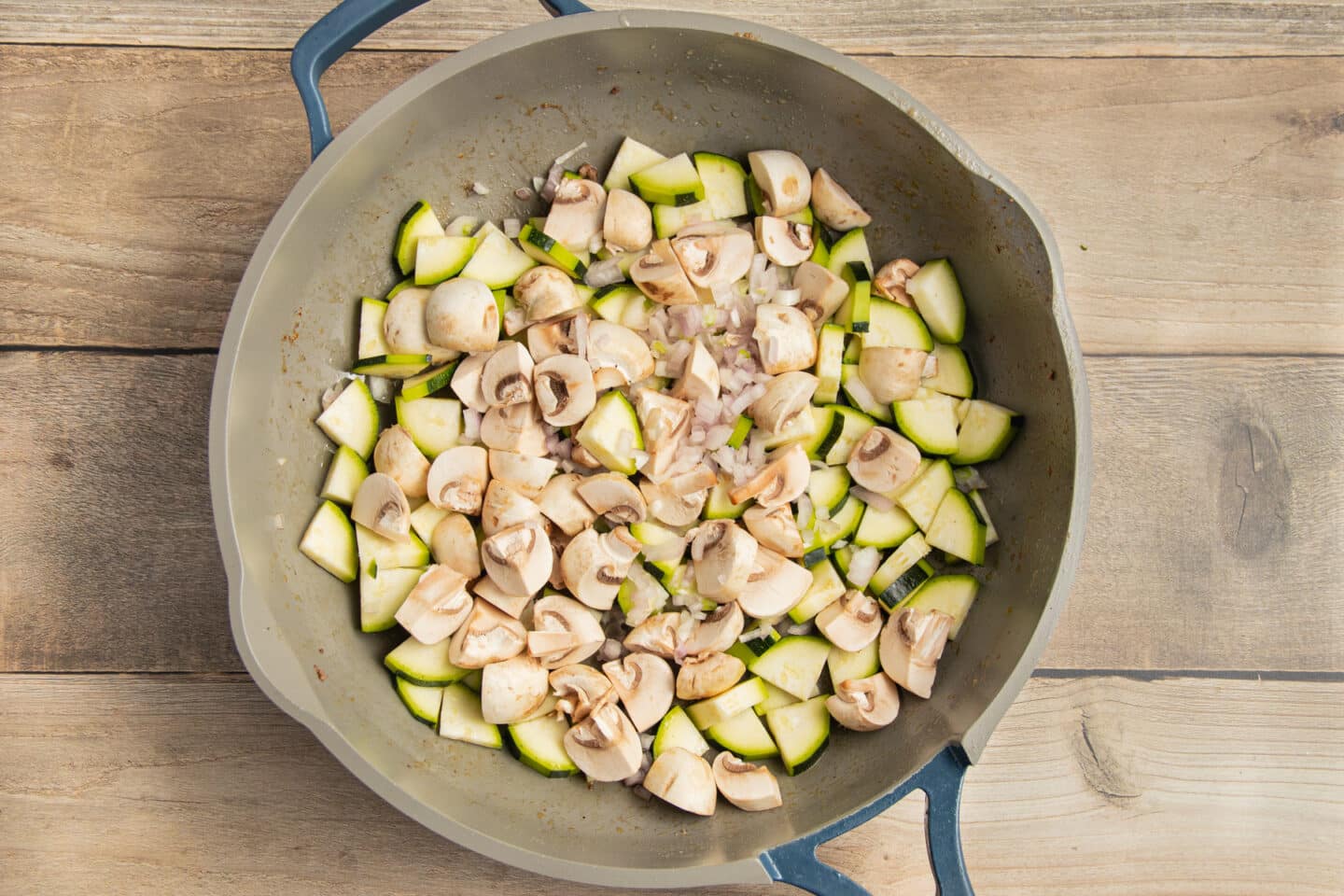 This is a picture of veggies cooking in a skillet.