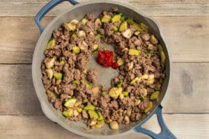 This is a picture of ground beef & veggies with added Dijon and tomato paste cooking in a skillet.