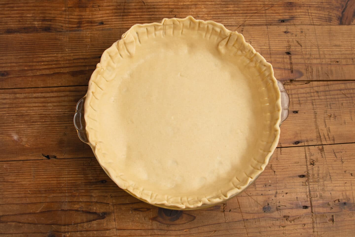 This is a picture of the crust in a pie dish.