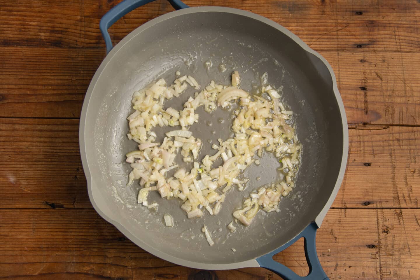 This is a picture of a skillet with shallots being caramelized.