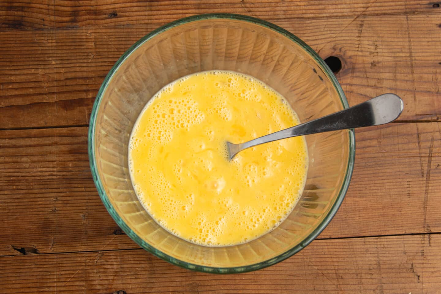 This is picture of the eggs being whisked in a bowl.