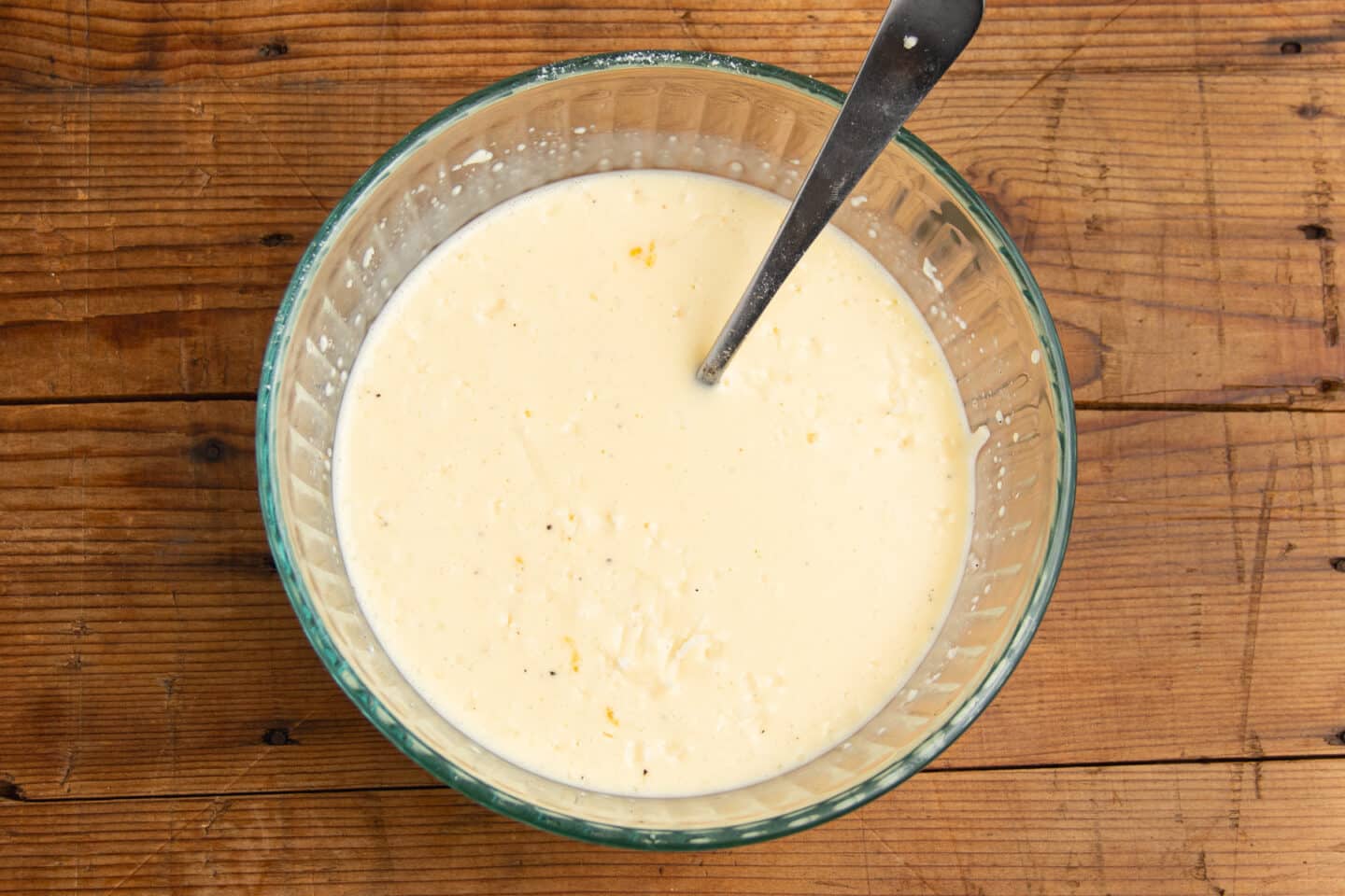 This is picture of the eggs in a bowl with milk and cheese added.