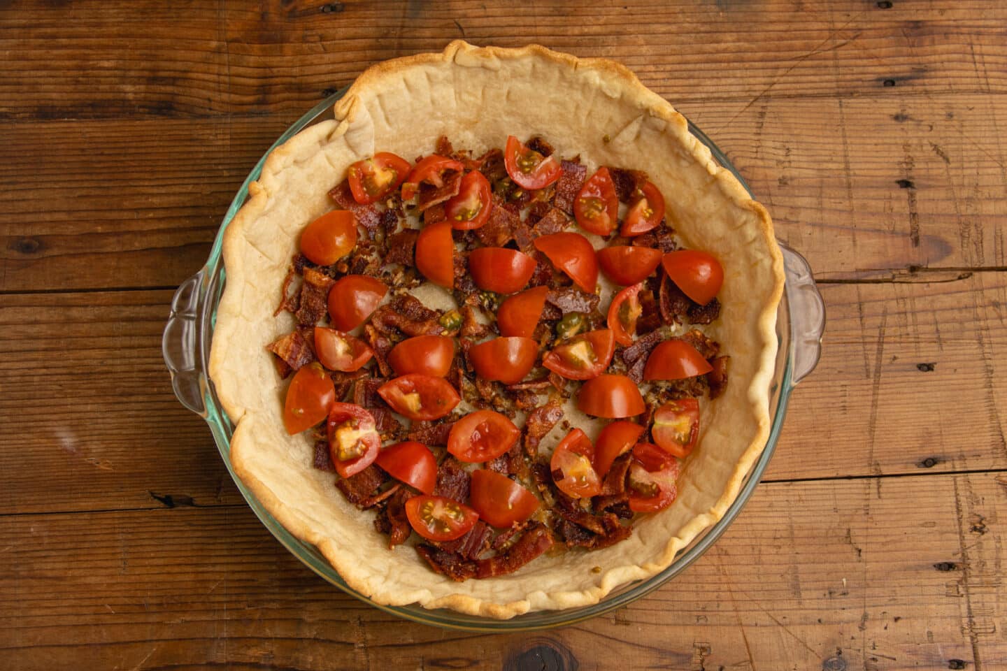 This is a picture of the crust with tomatoes added.