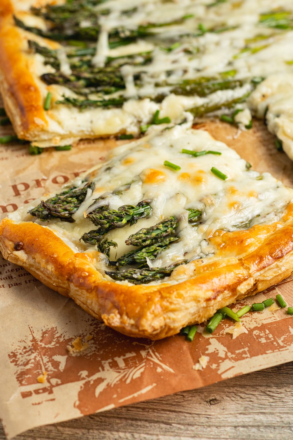 This is a picture of a slice of asparagus puff pastry tart with Boursin.