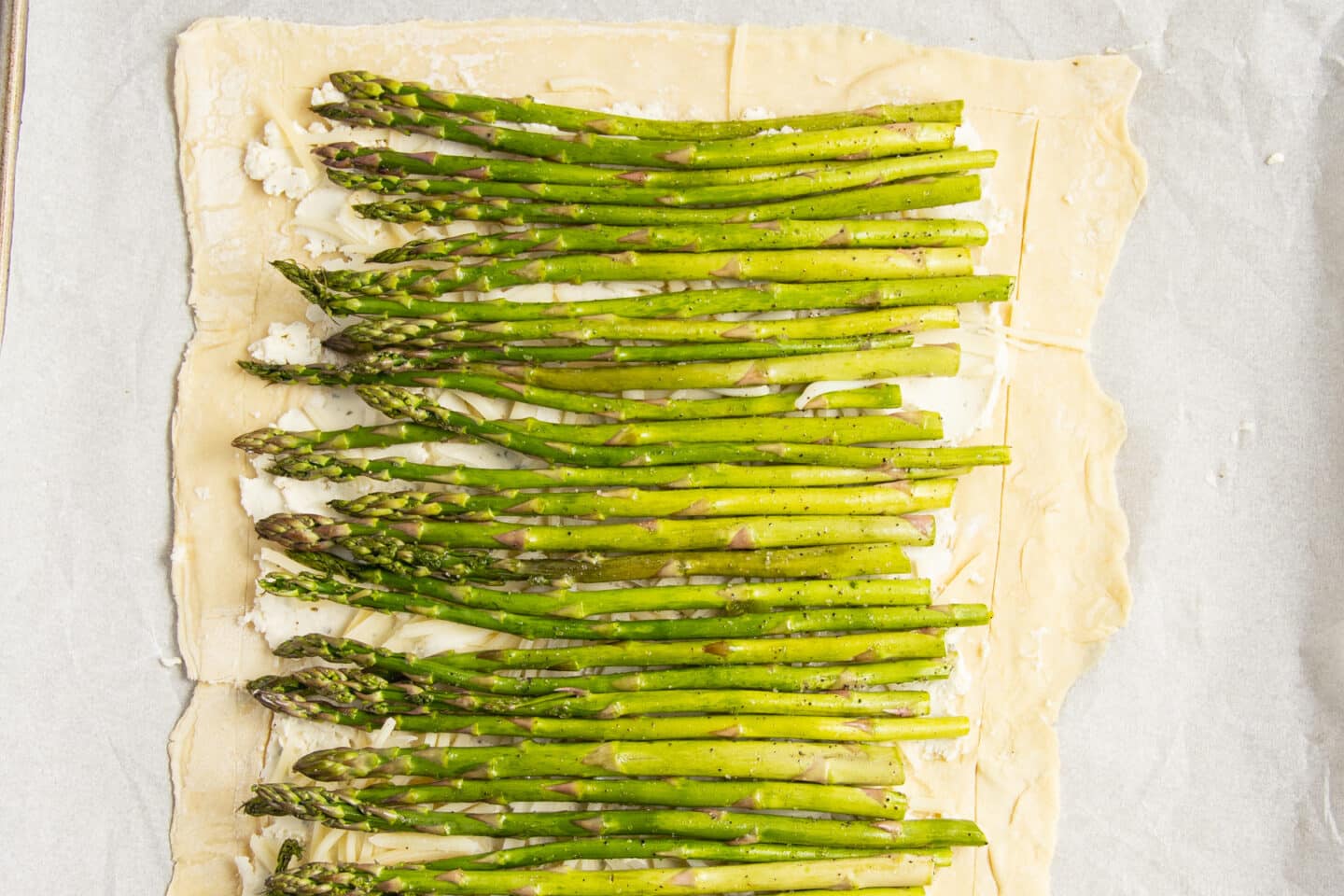 This is a picture of the puff pastry with the cheese and asparagus added.