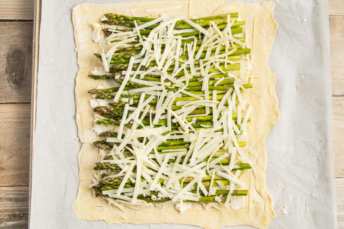 This is a picture of the puff pastry with asparagus and cheese added.