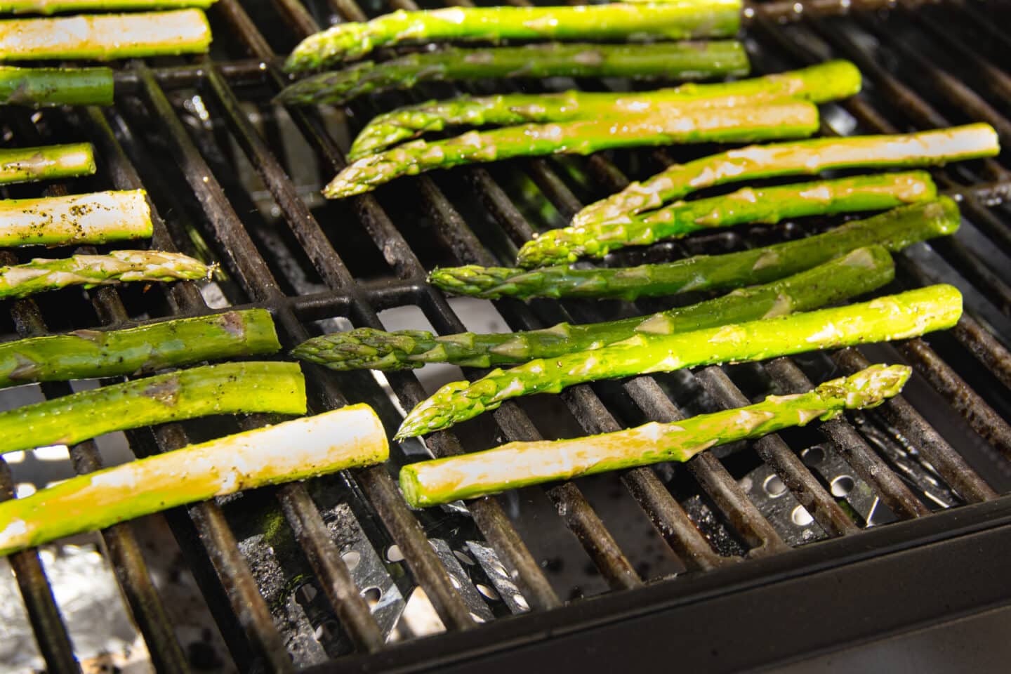 This is a picture of asparagus cooking on a grill.
