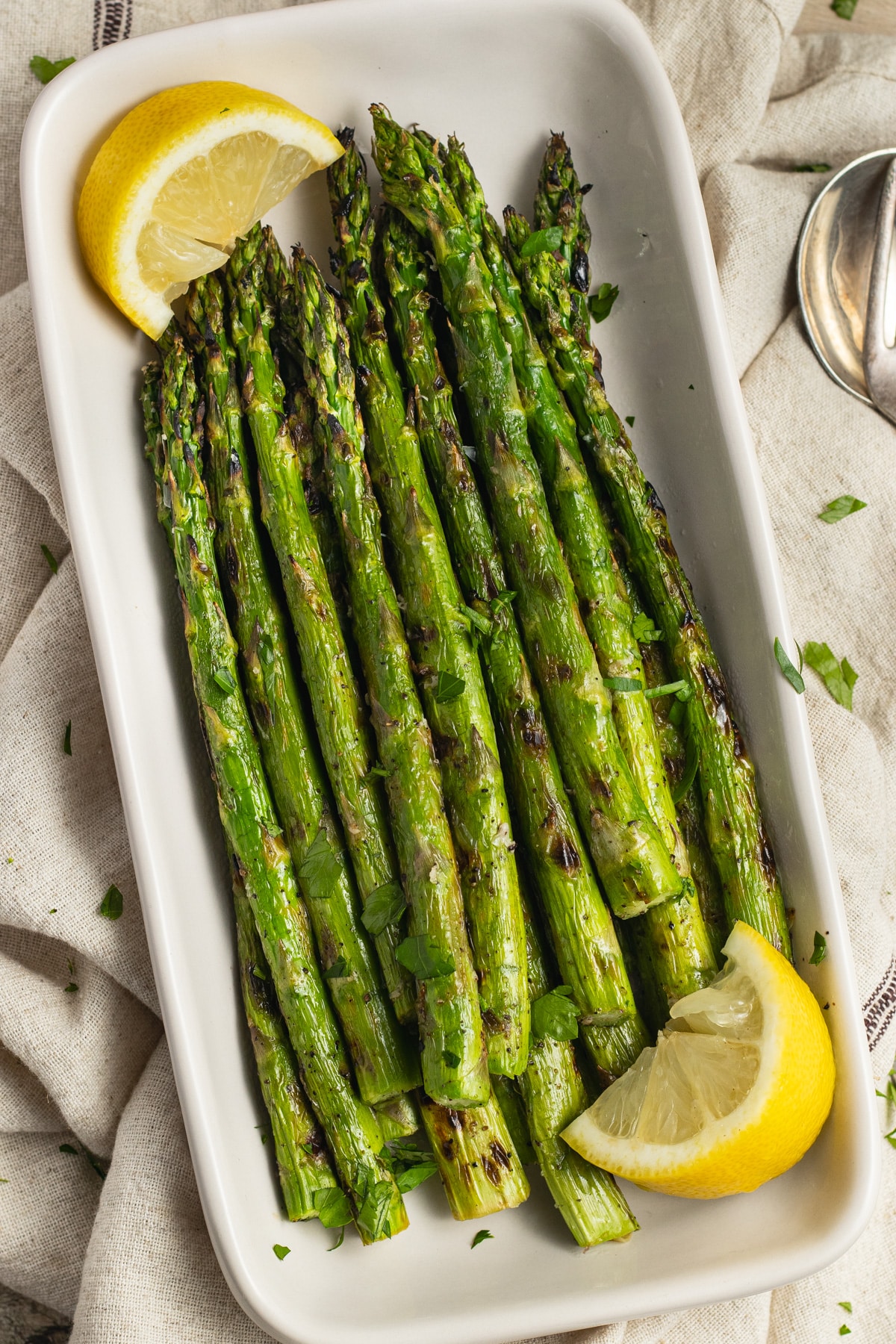 This is a picture of a dish filled with grilled asparagus.