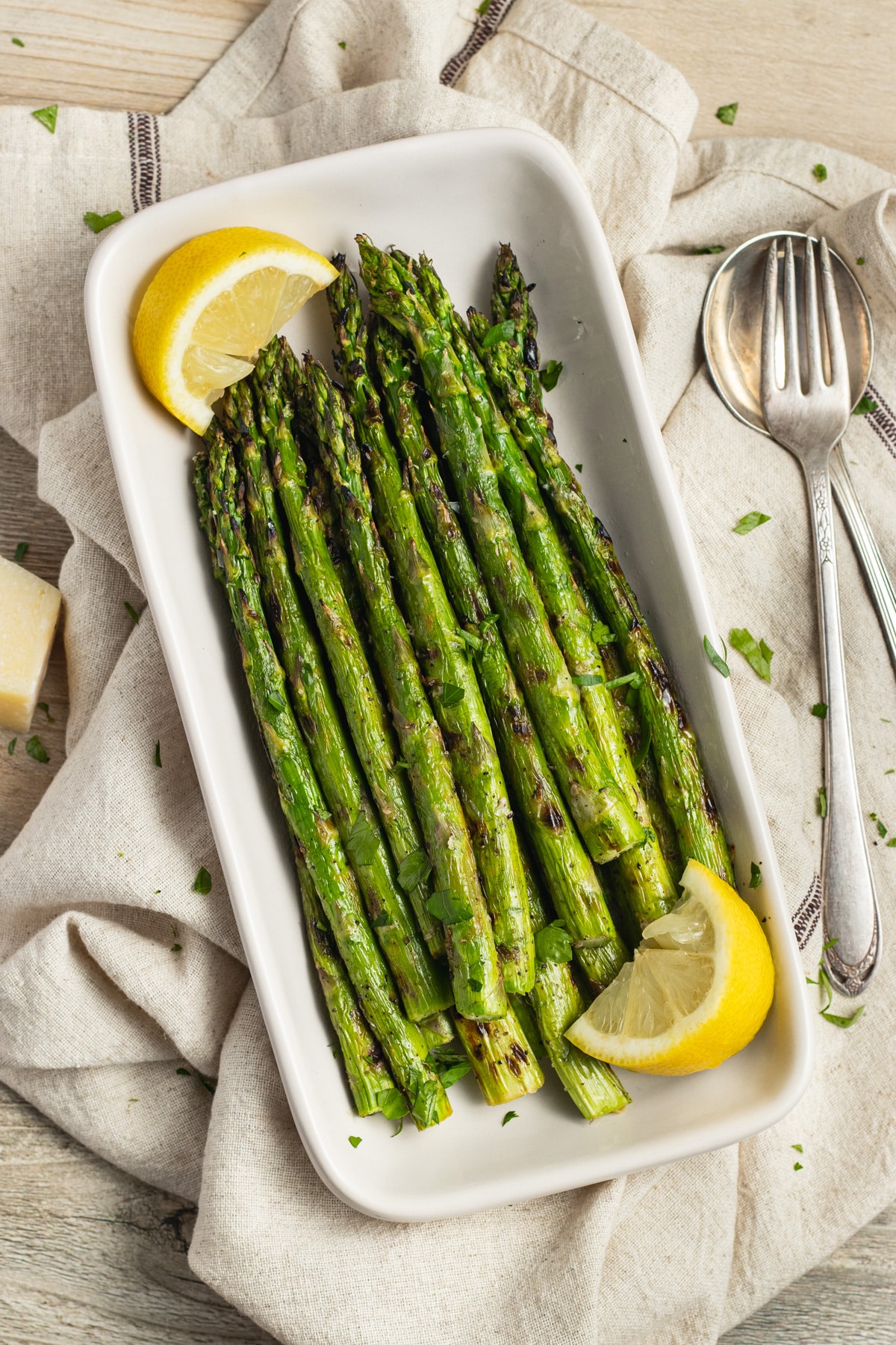 This is a picture of a dish filled with grilled asparagus.