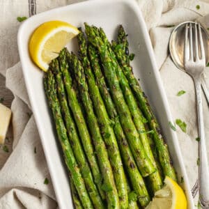 This is a picture of a dish filled with grilled asparagus.