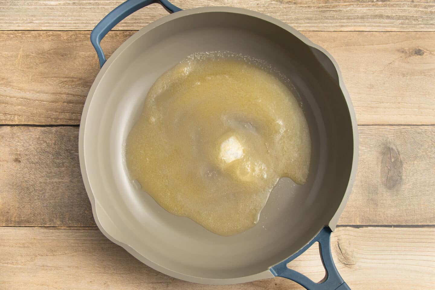 This is a picture of butter and sugar melting in a skillet.